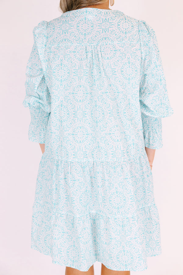 Chic Soul plus size clothing, teal knee length dress with half sleeves that have a ruffle flare out on the ends as well as a v-neckline circle abstract pattern throughout 
