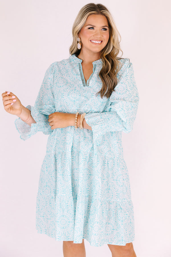 Chic Soul plus size clothing, teal knee length dress with half sleeves that have a ruffle flare out on the ends as well as a v-neckline circle abstract pattern throughout 
