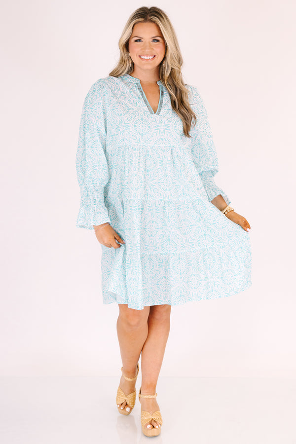Chic Soul plus size clothing, teal knee length dress with half sleeves that have a ruffle flare out on the ends as well as a v-neckline circle abstract pattern throughout 
