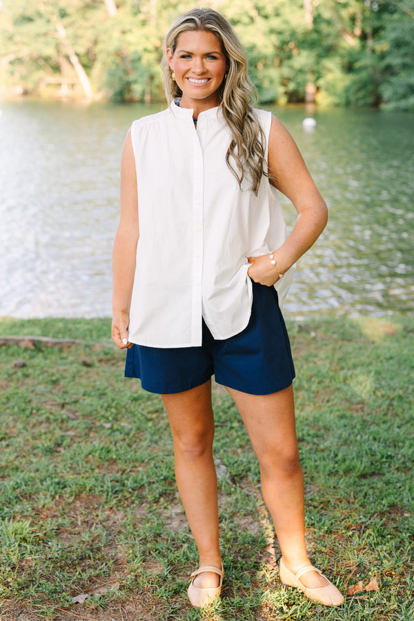 Plus Size white sleeveless button-down tank with a mandarin collar and navy blue shorts.
