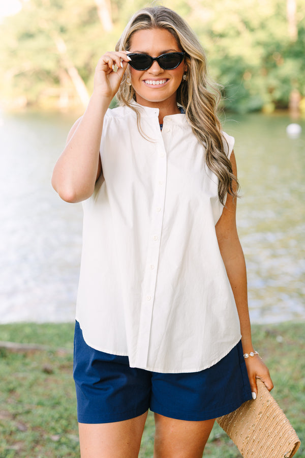 Plus Size white sleeveless button-down tank with a mandarin collar and navy blue shorts.