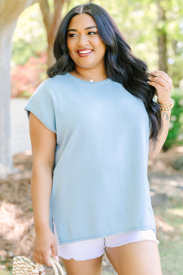 Lightweight blue knit sweater with cap sleeves and a relaxed fit.