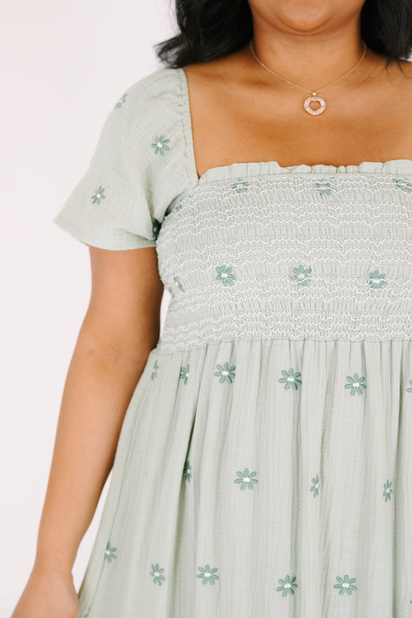 Chic Soul plus size clothing,  green maxi dress with a square neckline a smocked chest short sleeves and darker green floral embroidered pattern throughout