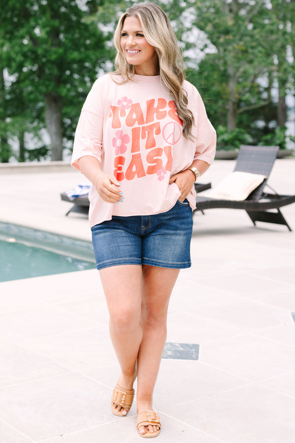 Plus Size blush pink vintage wash tee with a retro Take It Easy graphic and short sleeves.