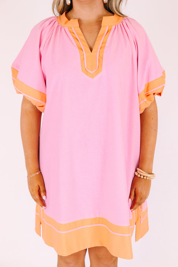 Chic Soul plus size clothing,  pink knee length dress with orange outlining the bottom of the dress the ends of the bubble sleeves and along the v-neckline