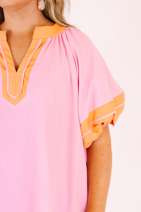 Chic Soul plus size clothing,  pink knee length dress with orange outlining the bottom of the dress the ends of the bubble sleeves and along the v-neckline