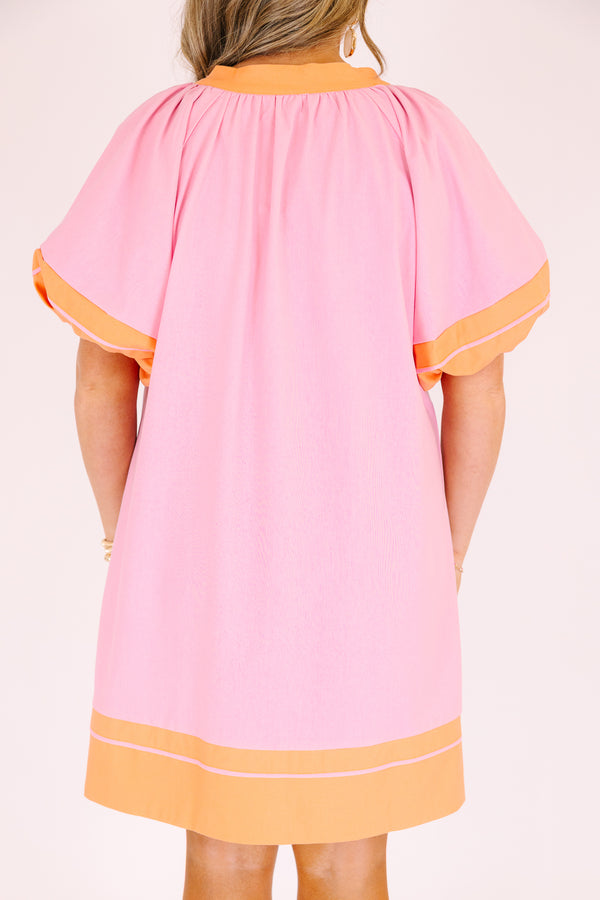 Chic Soul plus size clothing,  pink knee length dress with orange outlining the bottom of the dress the ends of the bubble sleeves and along the v-neckline