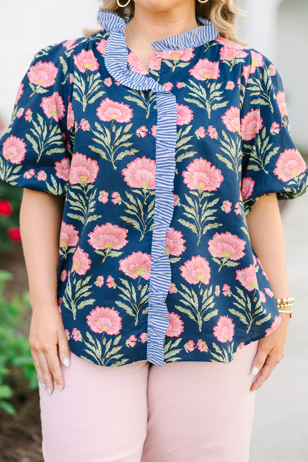 Navy floral cotton top with puff sleeves and a blue and white striped ruffle trim.