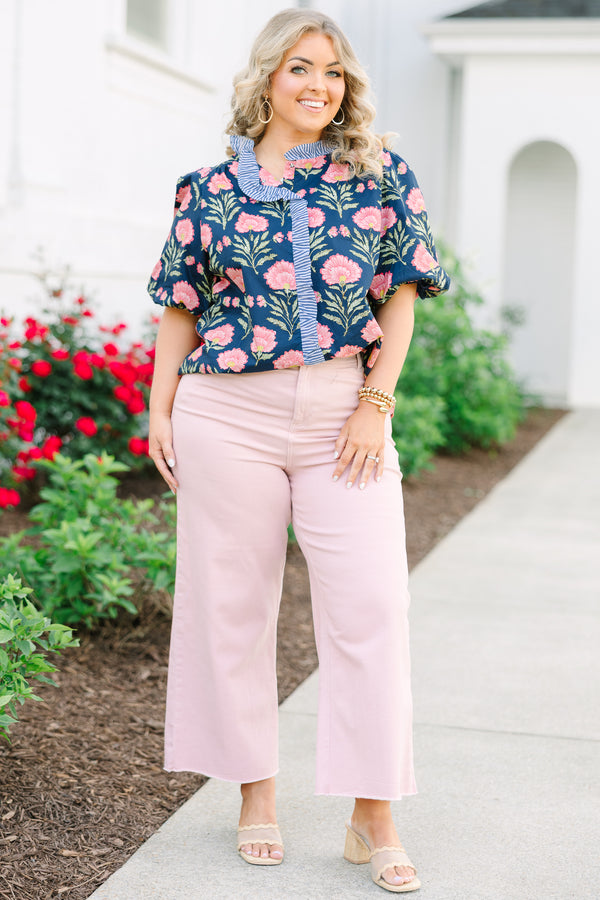 Navy floral top with elastic puff sleeves and blue and white striped ruffle trim.