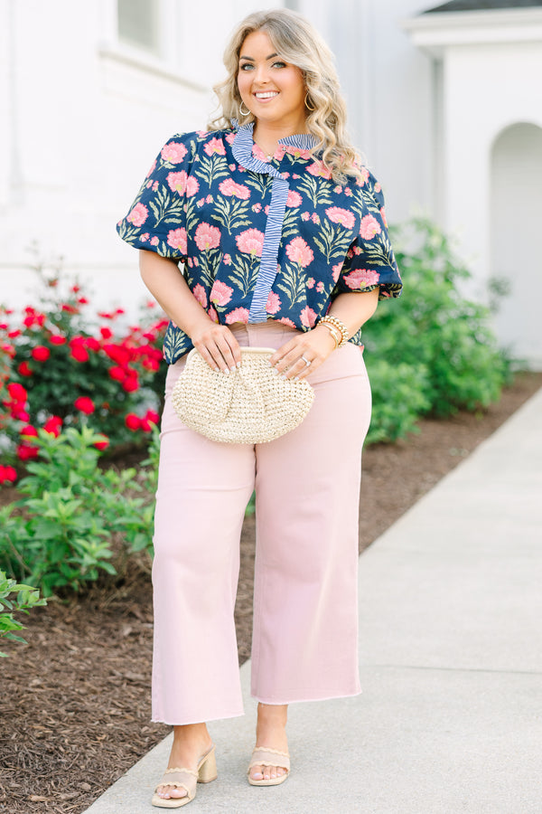 Navy floral top with elastic puff sleeves and blue and white striped ruffle trim.