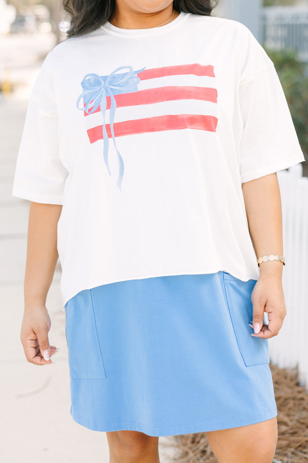 Chic Soul plus size clothing, white short sleeve slightly cropped tee with watercolor abstract American flag and light blue bow on it