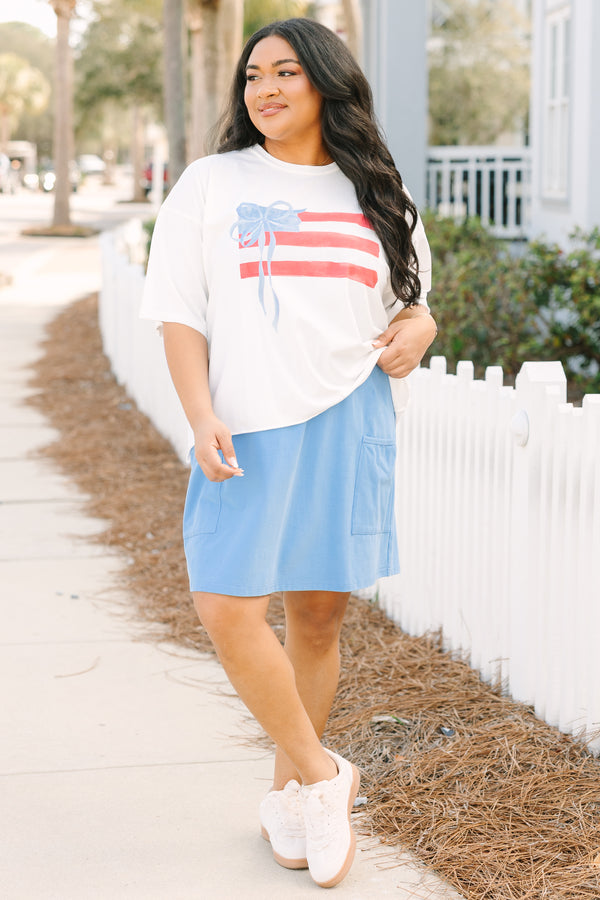 Chic Soul plus size clothing, white short sleeve slightly cropped tee with watercolor abstract American flag and light blue bow on it