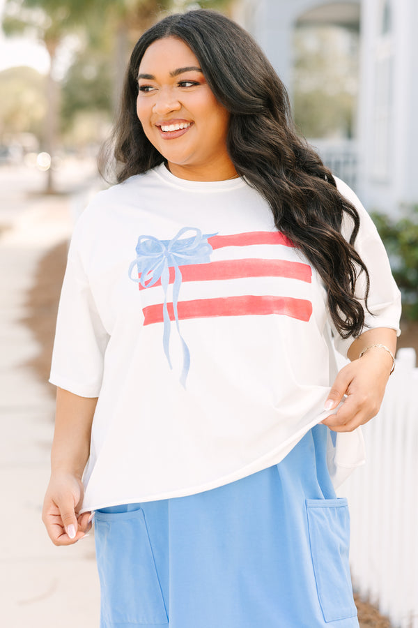 Chic Soul plus size clothing, white short sleeve slightly cropped tee with watercolor abstract American flag and light blue bow on it