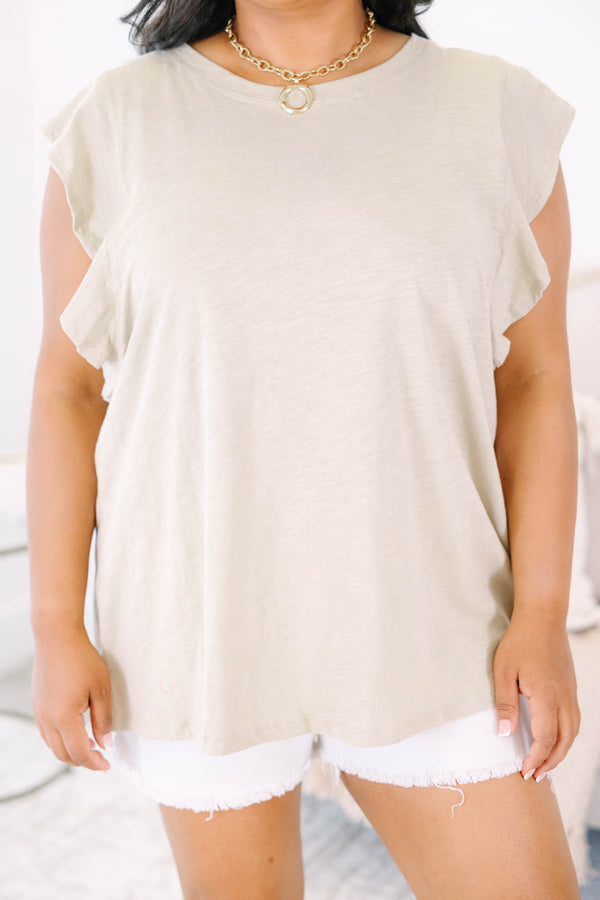 Plus Size light mocha top with a round neckline and ruffled cap sleeves paired with white shorts.