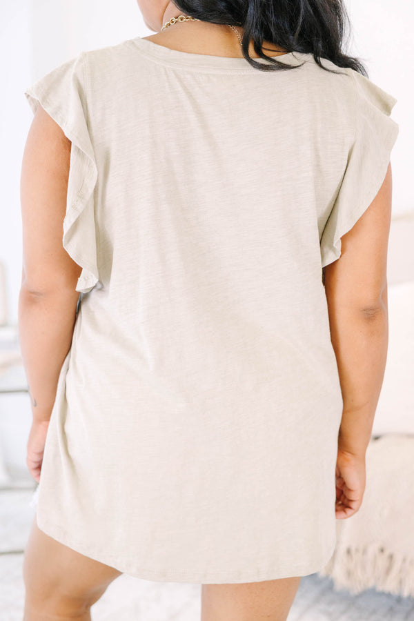 Plus Size light mocha top with a round neckline and ruffled cap sleeves paired with white shorts.