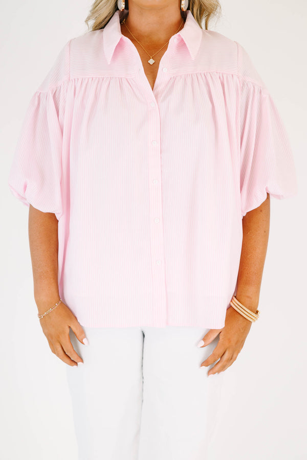 Plus size pink button up blouse with puff sleeves and a flowy fit.