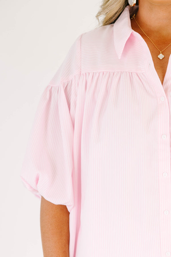 Plus size pink button up blouse with puff sleeves and a flowy fit.