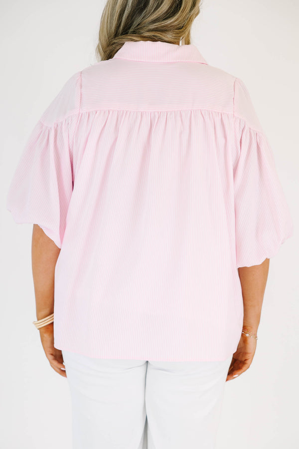 Plus size pink button up blouse with puff sleeves and a flowy fit.