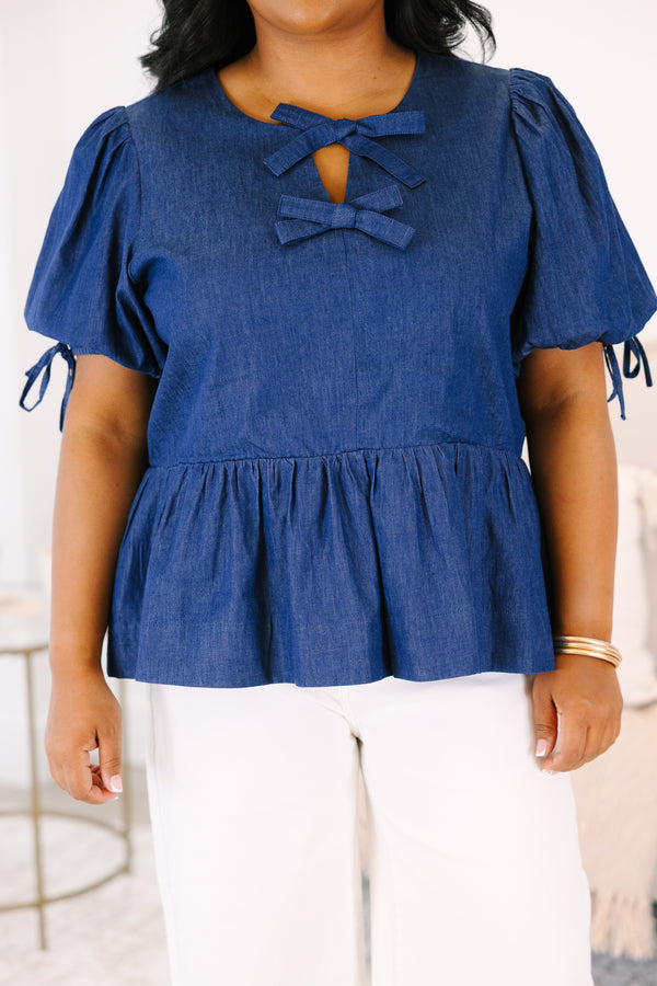 Plus Size denim peplum top with puff sleeves and double bow keyhole neckline.