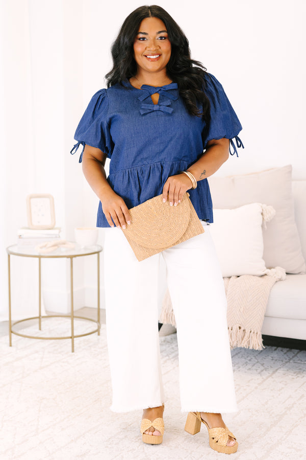 Plus Size denim peplum top with puff sleeves and double bow keyhole neckline.