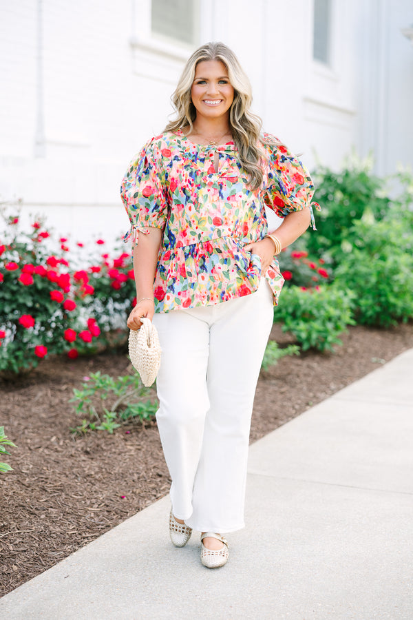 Plus size pink floral watercolor peplum top with puff sleeves and a bow neckline detail.