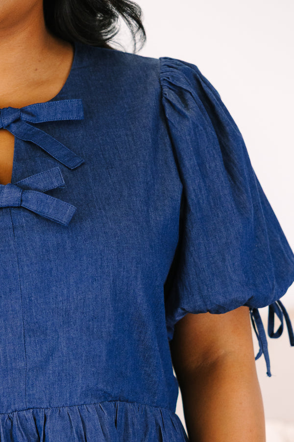 Plus Size denim peplum top with puff sleeves and double bow keyhole neckline.