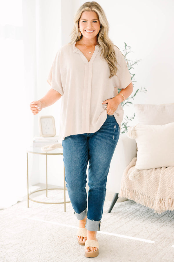 Plus Size dark wash skinny jeans with distressed details and cuffed hems.