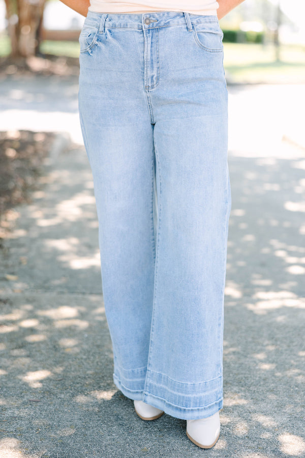 Plus Size light wash wide-leg jeans with a relaxed fit and wide stitched hem detail.
