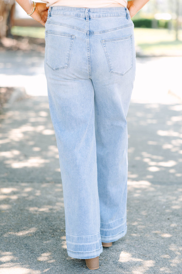Plus Size light wash wide-leg jeans with a relaxed fit and wide stitched hem detail.