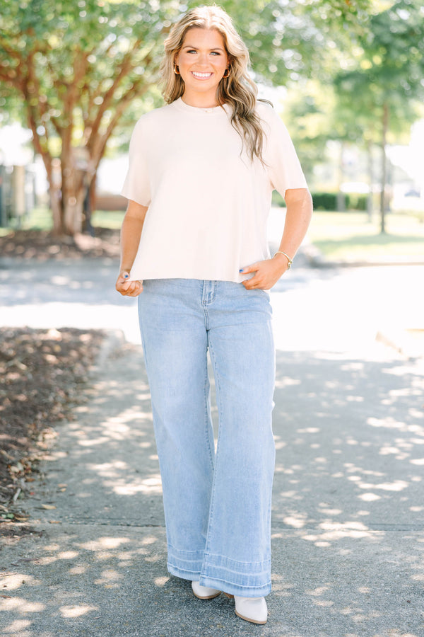 Plus Size light wash wide-leg jeans with a relaxed fit and wide stitched hem detail.