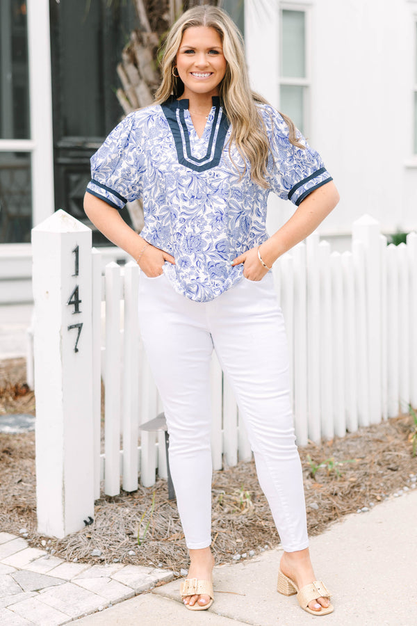 Chic Soul plus size clothing, white and light blue floral pattern puff sleeve top with navy blue trim along the bottom of the sleeves and outlining the v-neckline