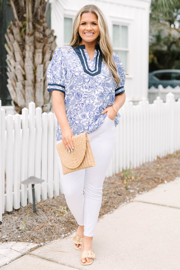 Chic Soul plus size clothing, white and light blue floral pattern puff sleeve top with navy blue trim along the bottom of the sleeves and outlining the v-neckline