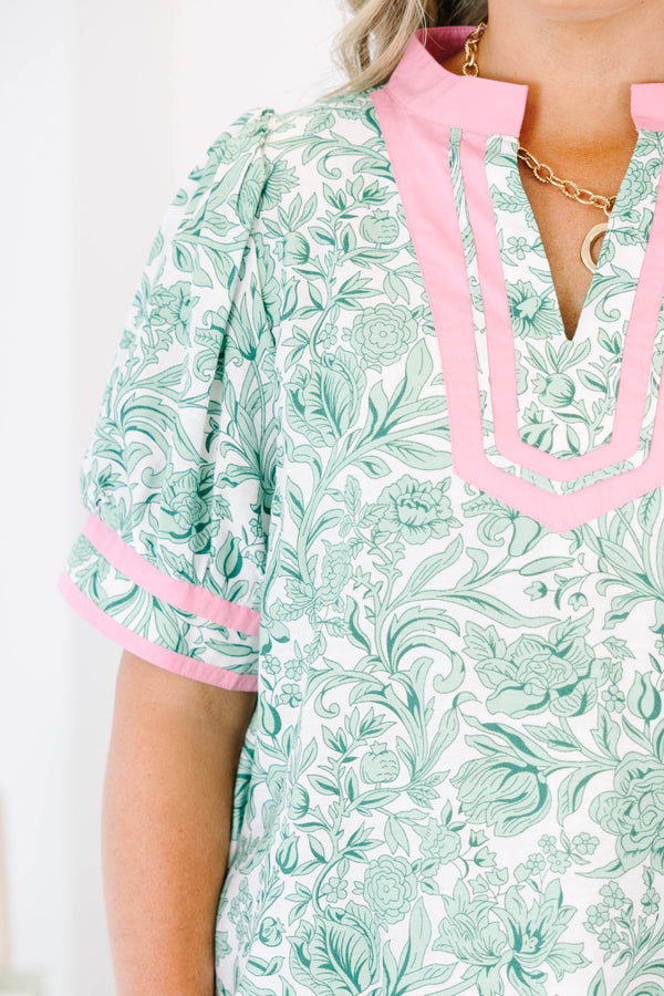 Plus Size green and white floral print top with pink trim, split neckline, and puff sleeves.