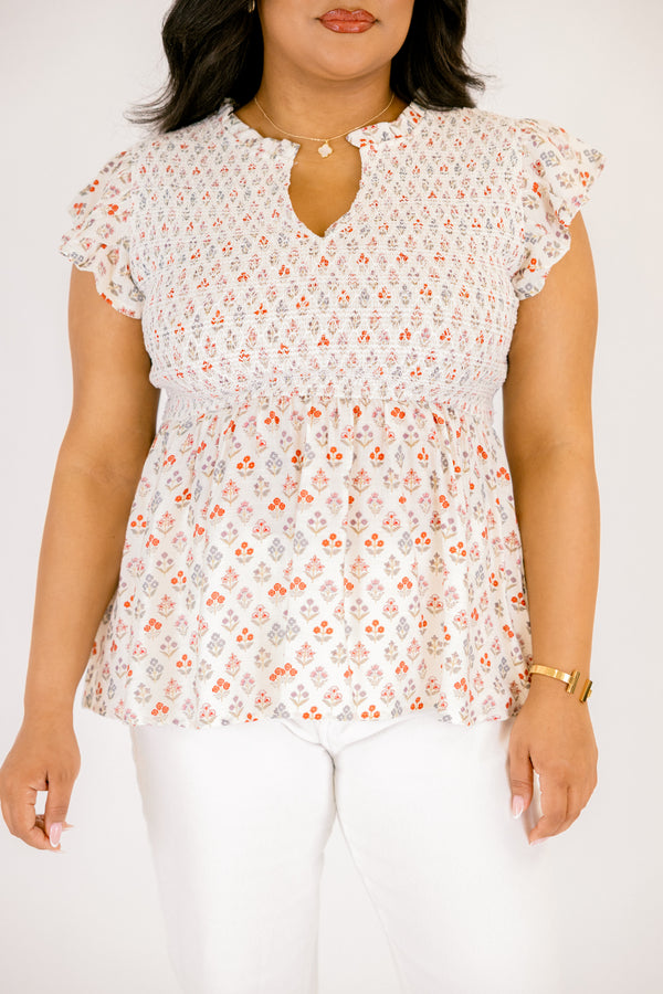 Chic Soul plus size clothing, white short flutter sleeve baby doll top with orange and light pink small abstract floral design and v-neckline