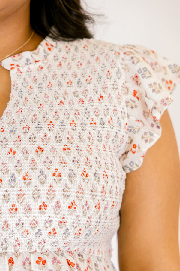 Chic Soul plus size clothing, white short flutter sleeve baby doll top with orange and light pink small abstract floral design and v-neckline