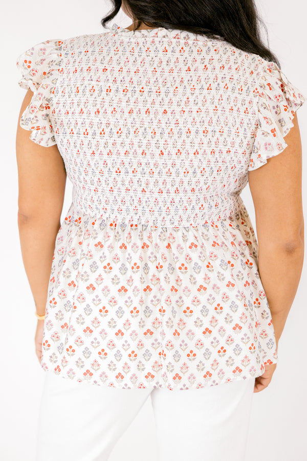 Chic Soul plus size clothing, white short flutter sleeve baby doll top with orange and light pink small abstract floral design and v-neckline