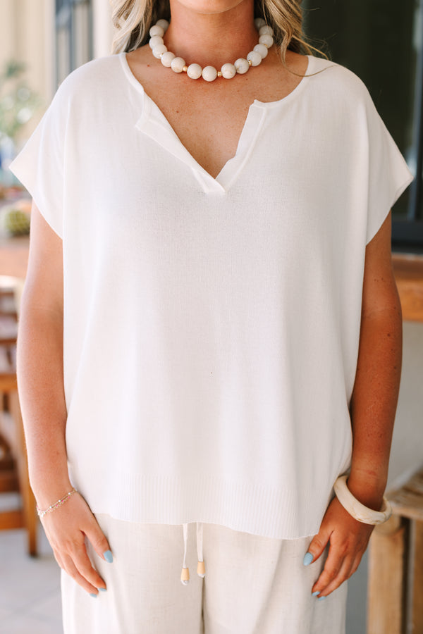 Short sleeve v-neck sweater in off-white with a relaxed fit and textured knit fabric.
