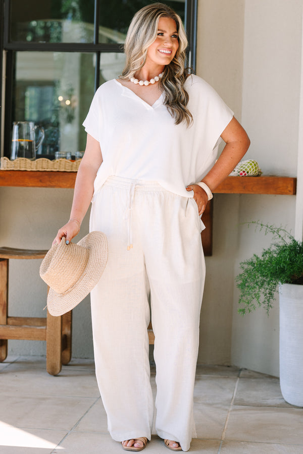 Short sleeve v-neck sweater in off-white with a relaxed fit and textured knit fabric.