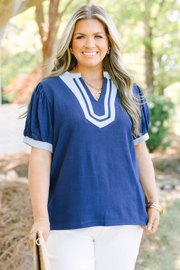Chic Soul plus size clothing, navy short puff sleeve top with v neck cutout and light blue trim around the neckline and sleeves
