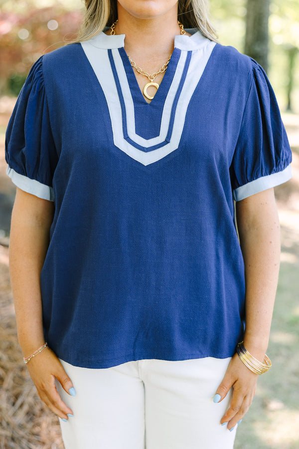 Chic Soul plus size clothing, navy short puff sleeve top with v neck cutout and light blue trim around the neckline and sleeves
