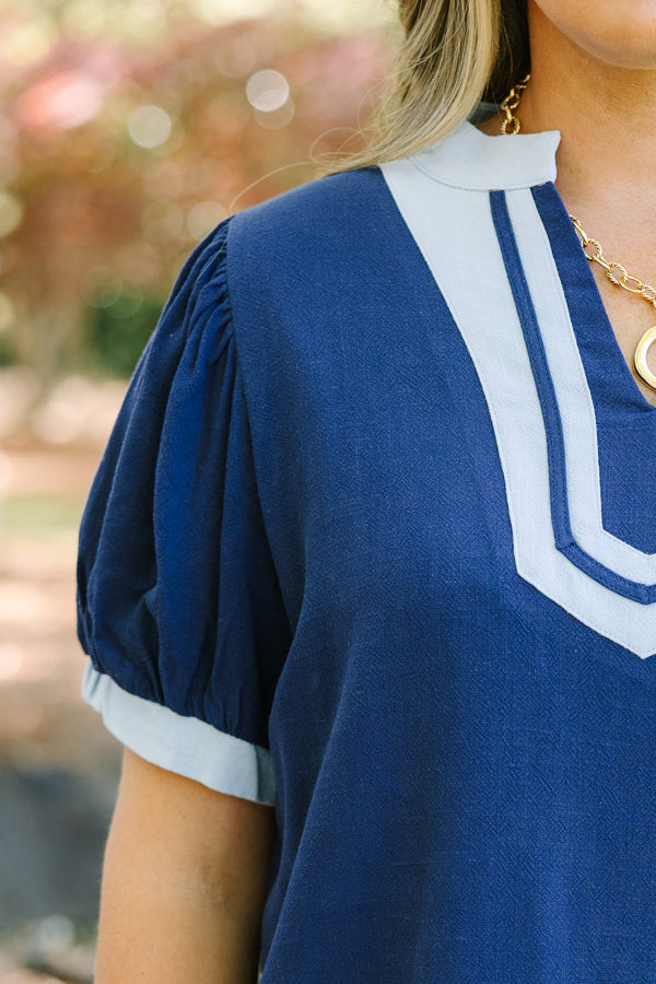 Chic Soul plus size clothing, navy short puff sleeve top with v neck cutout and light blue trim around the neckline and sleeves