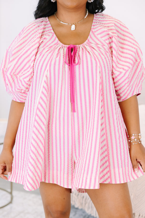 Plus Size pink and white vertical striped romper with puff sleeves and a tie-front neckline.