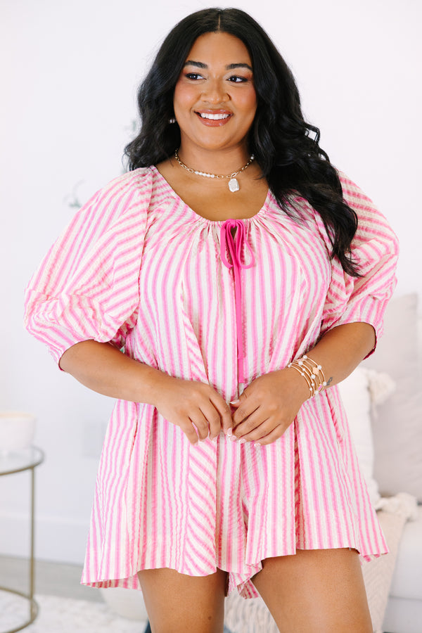 Plus Size pink and white vertical striped romper with puff sleeves and a tie-front neckline.