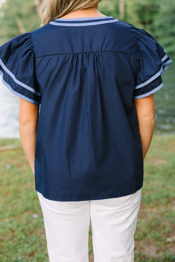 Plus Size navy blue top with light blue embroidery, V-neckline, and tiered flutter sleeves.
