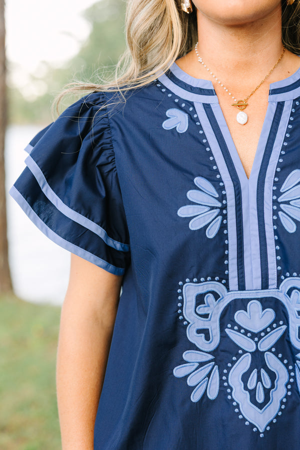 Plus Size navy blue top with light blue embroidery, V-neckline, and tiered flutter sleeves.