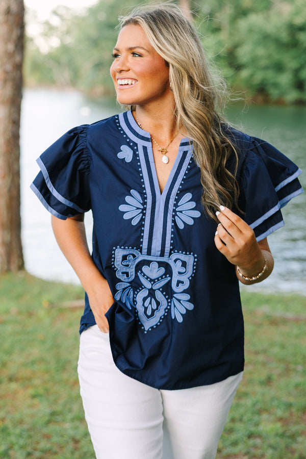 Plus Size navy blue top with light blue embroidery, V-neckline, and tiered flutter sleeves.