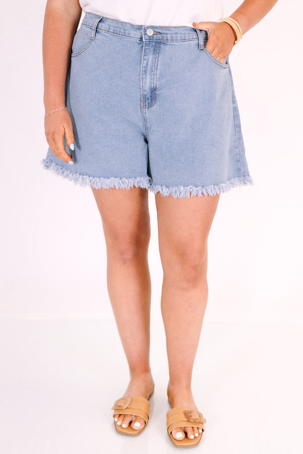 Chic Soul plus size clothing, a pair of denim shorts featuring a moderately full distressed raw hem in a medium-light wash