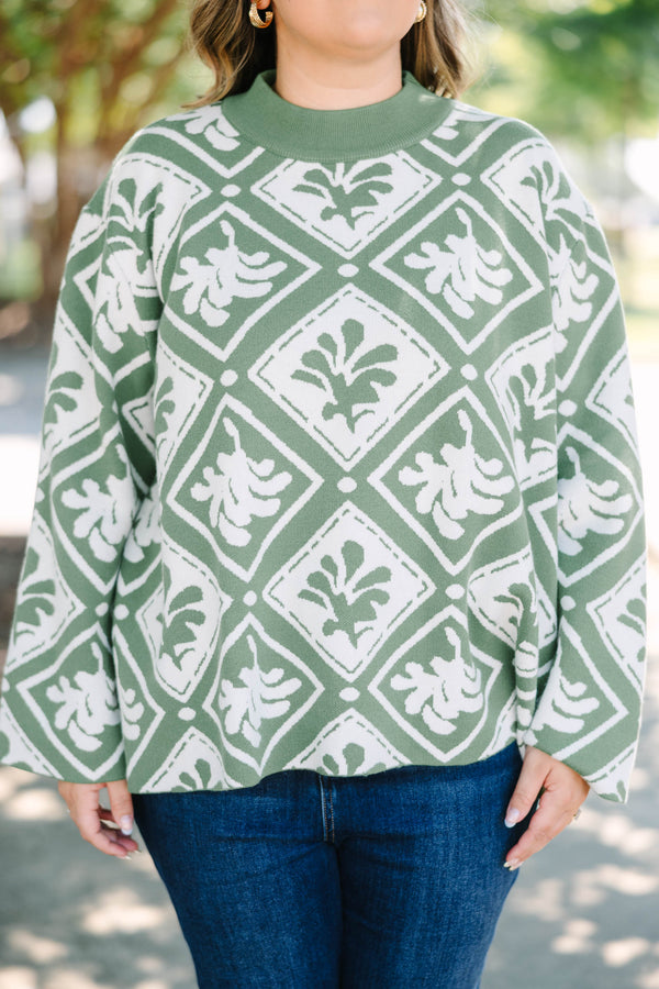 Plus Size green mock-neck sweater with a white diamond and floral-abstract print and wide sleeves.