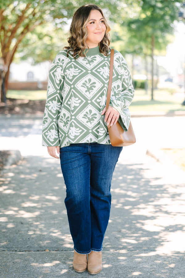 Plus Size green mock-neck sweater with a white diamond and floral-abstract print and wide sleeves.