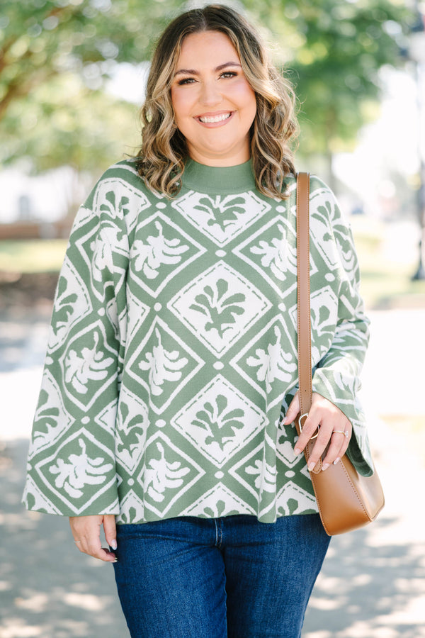 Plus Size green mock-neck sweater with a white diamond and floral-abstract print and wide sleeves.